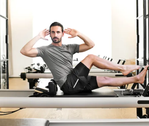 Man performing a pilates leg stretch