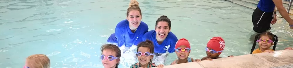 Children smiling for a picture at a Swim Lesson class